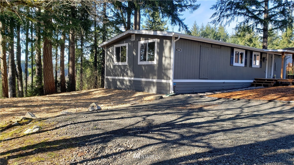 1040 Northeast Larson Boulevard Belfair, WA 98528 - Photo 29 of 31 a front view of a house with a yard