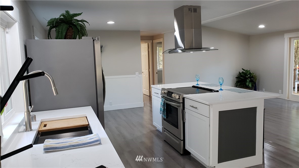 1040 Northeast Larson Boulevard Belfair, WA 98528 - Photo 4 of 31 a kitchen with a refrigerator and a sink