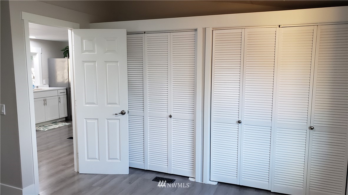 1040 Northeast Larson Boulevard Belfair, WA 98528 - Photo 10 of 31 a view of a hallway with bathroom and wooden floor