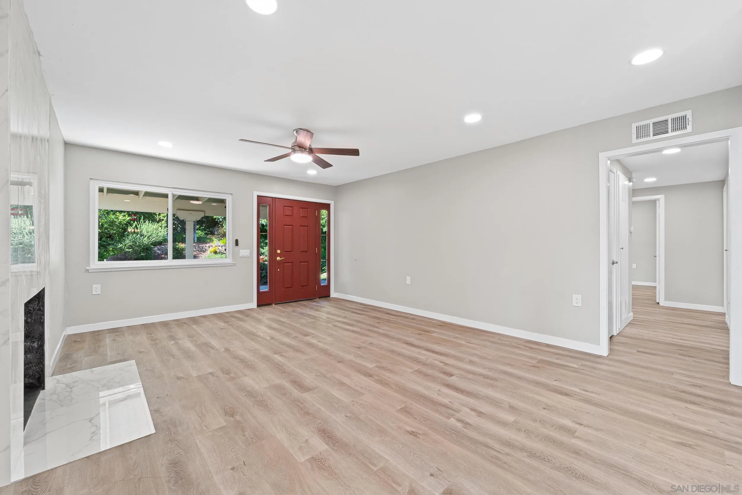12424 Rios Road San Diego, CA 92128 - Photo 11 of 35 a view of an empty room with a window and wooden floor