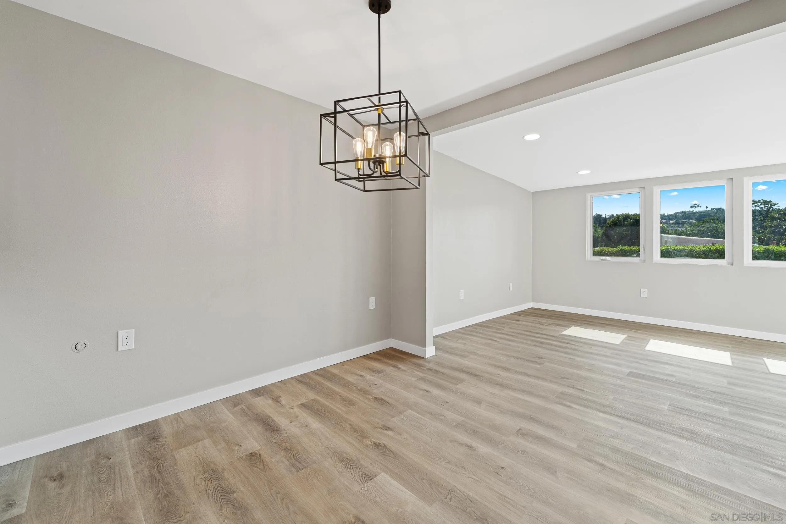 12424 Rios Road San Diego, CA 92128 - Photo 13 of 35 a view of empty room with wooden floor and window
