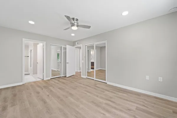 a view of empty room with wooden floor