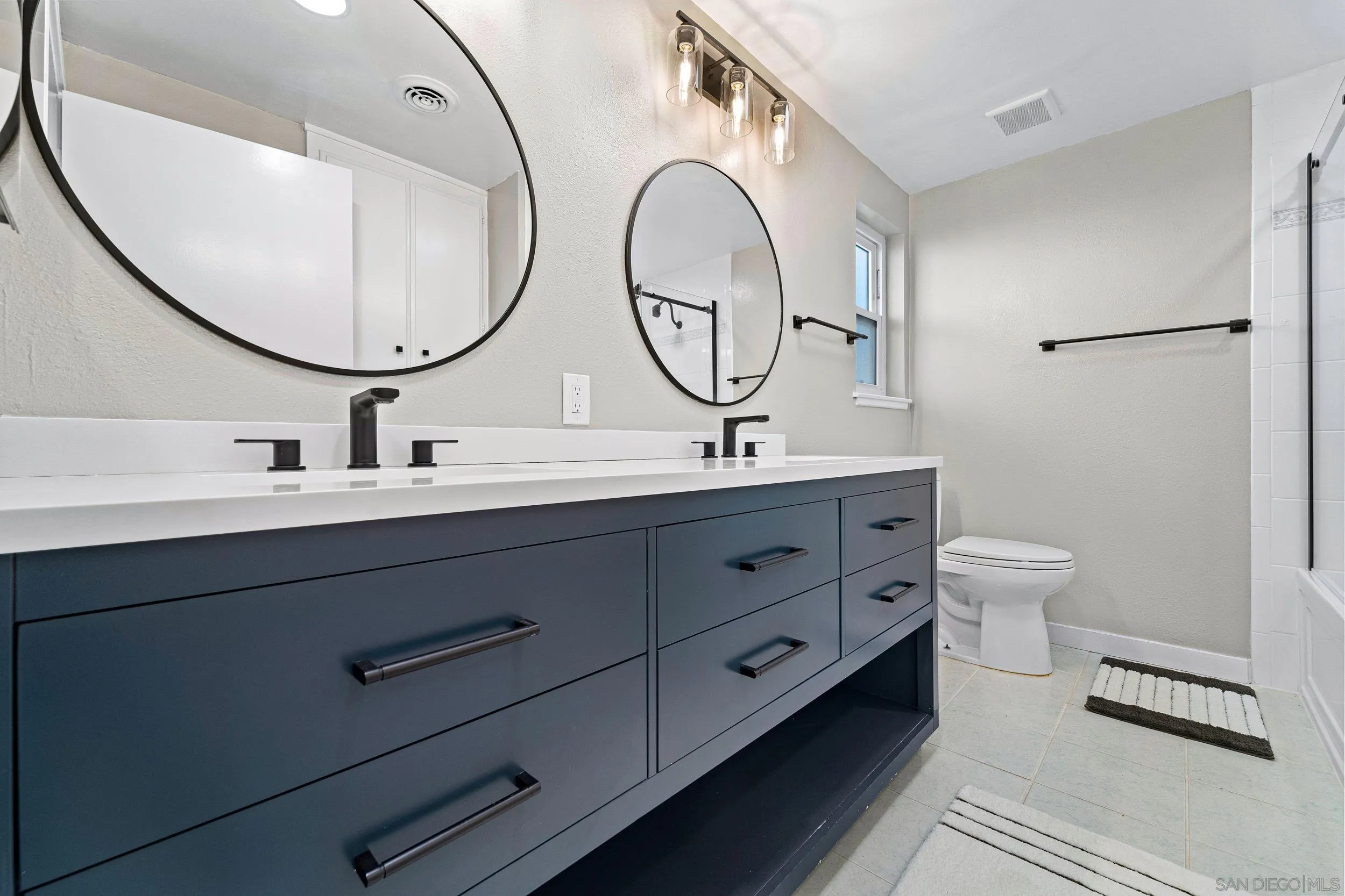 12424 Rios Road San Diego, CA 92128 - Photo 21 of 35 a bathroom with a double vanity sink mirror and toilet
