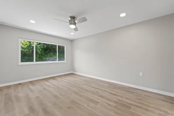 wooden floor in an empty room with a window