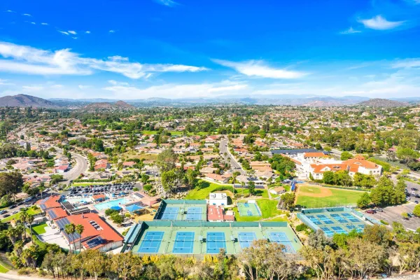 an aerial view of residential houses with outdoor space and street view