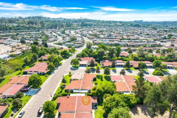 an aerial view of residential houses with outdoor space
