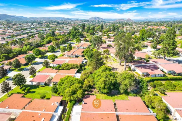 an aerial view of residential houses with outdoor space and street view