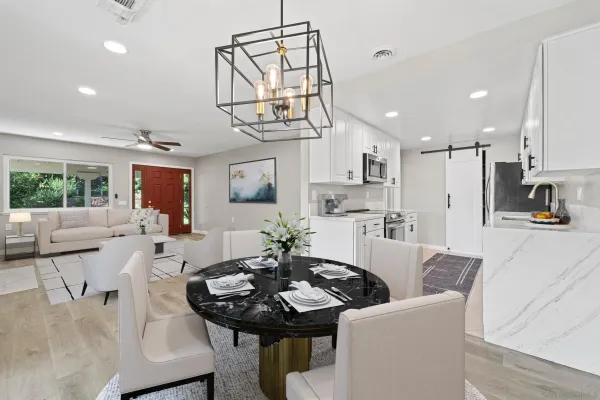 a view of a dining room with furniture and a chandelier