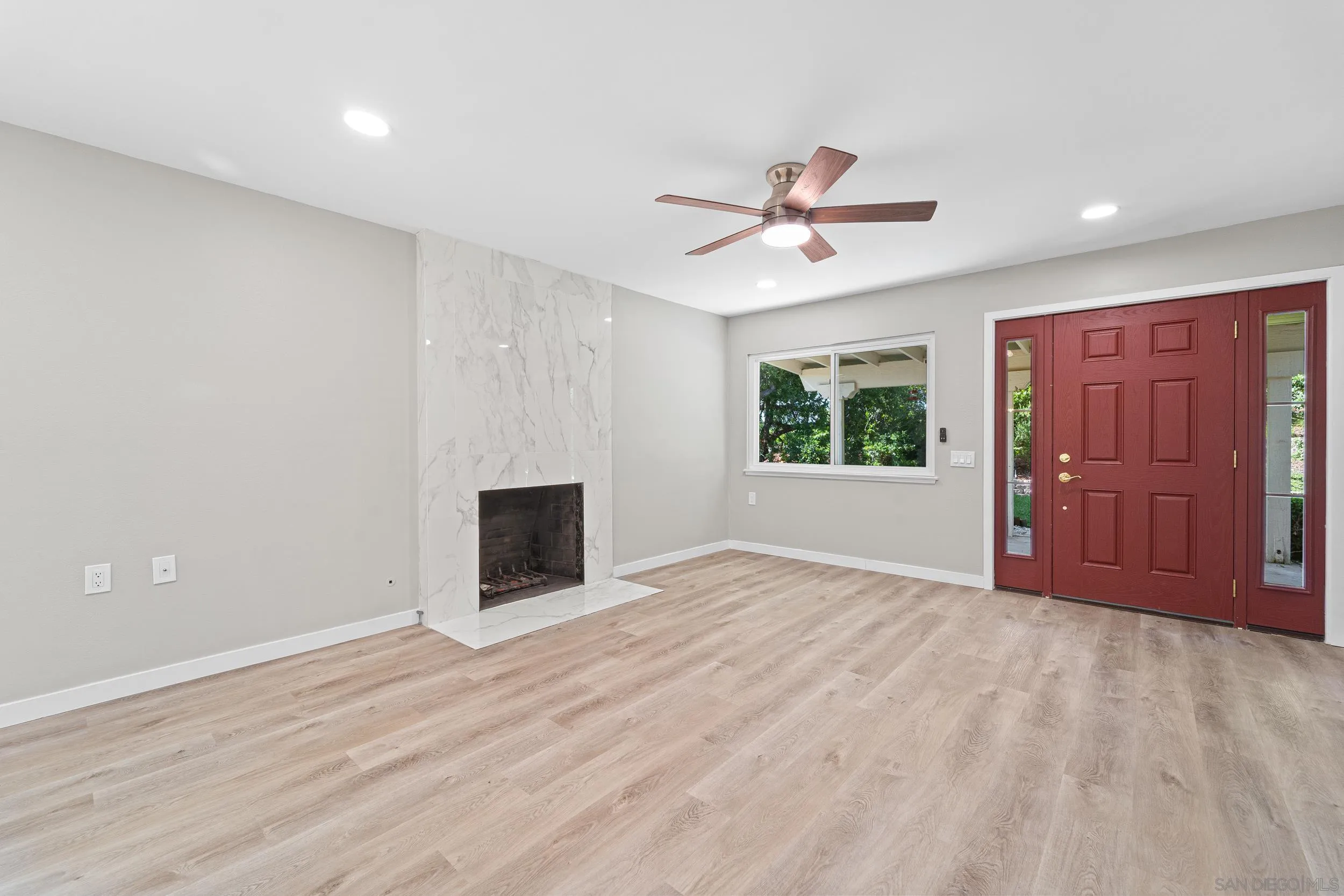 12424 Rios Road San Diego, CA 92128 - Photo 8 of 35 a view of an empty room with a window and a kitchen