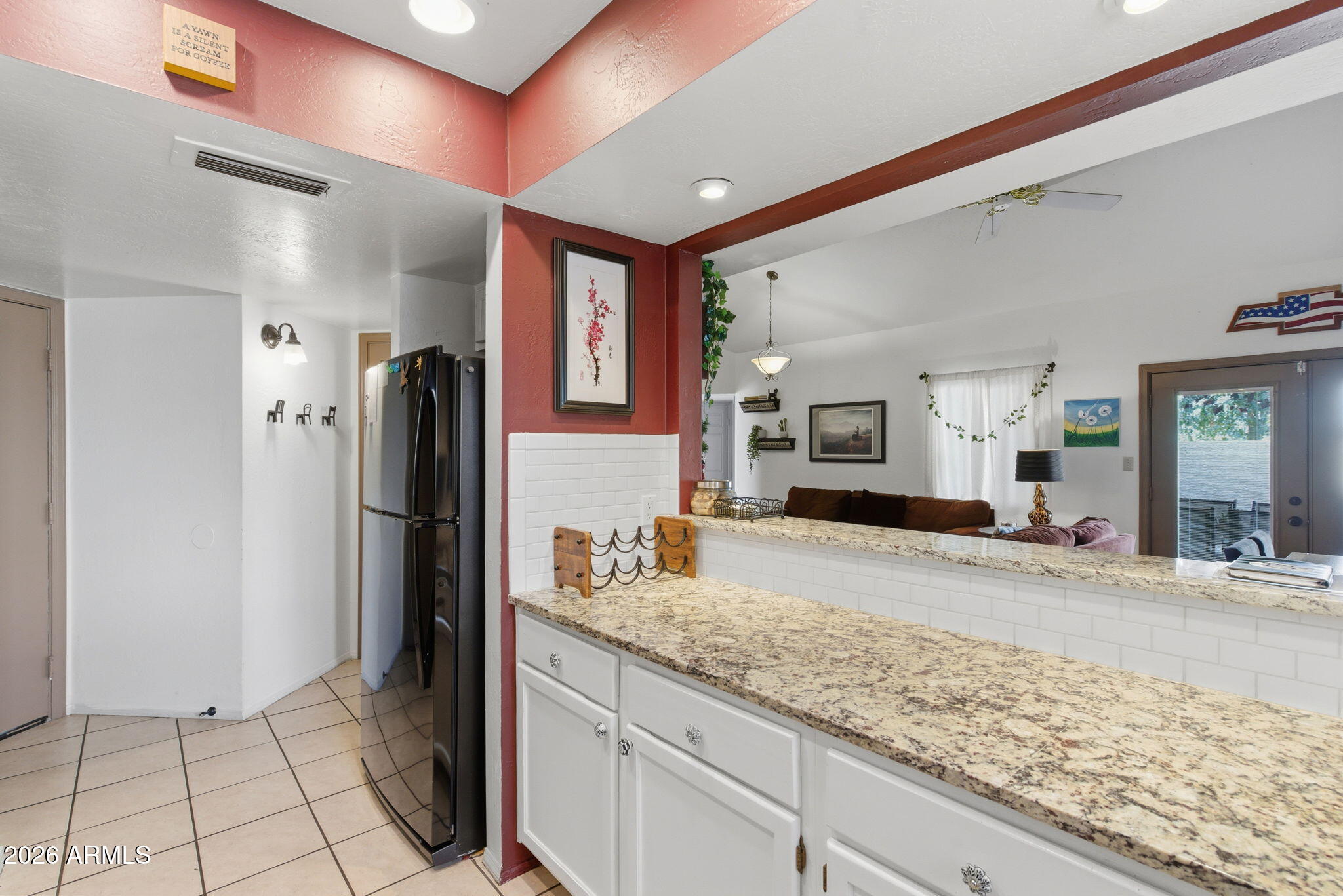 4218 West Boca Raton Road Phoenix, AZ 85053 - Photo 6 of 27 a kitchen with refrigerator and natural light