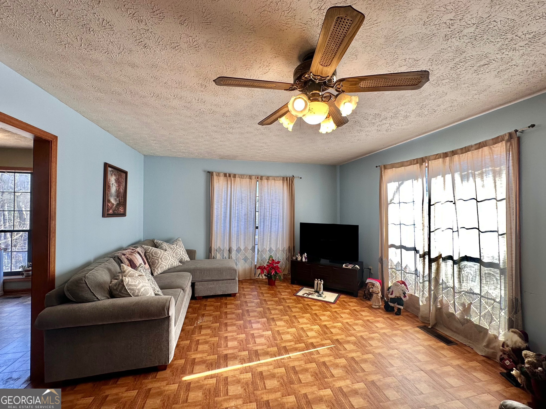 276 Oglesby Bridge Road Southeast Conyers, GA 30094 - Photo 27 of 49 a living room with furniture and a flat screen tv