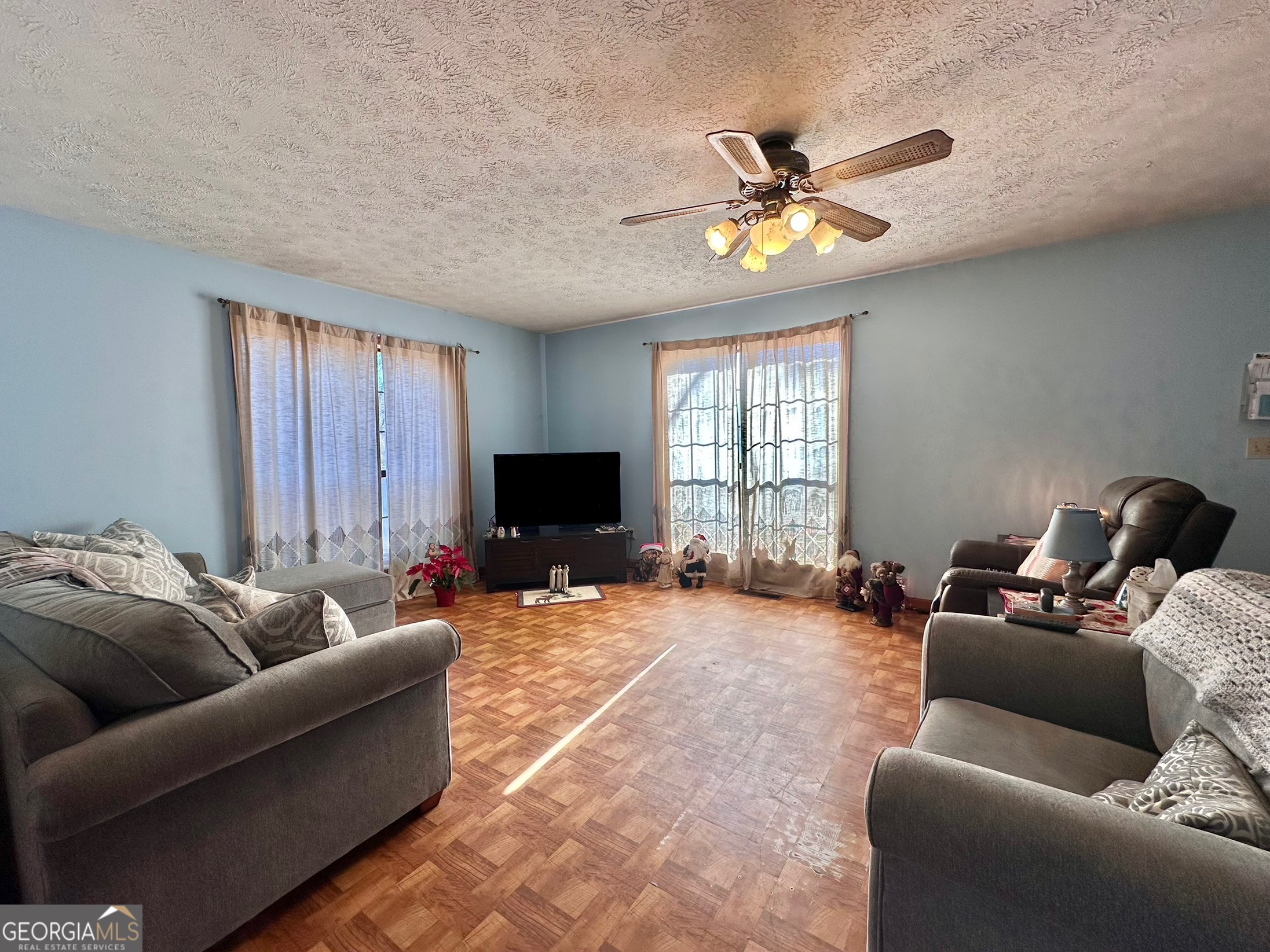 276 Oglesby Bridge Road Southeast Conyers, GA 30094 - Photo 28 of 49 a living room with furniture and a flat screen tv