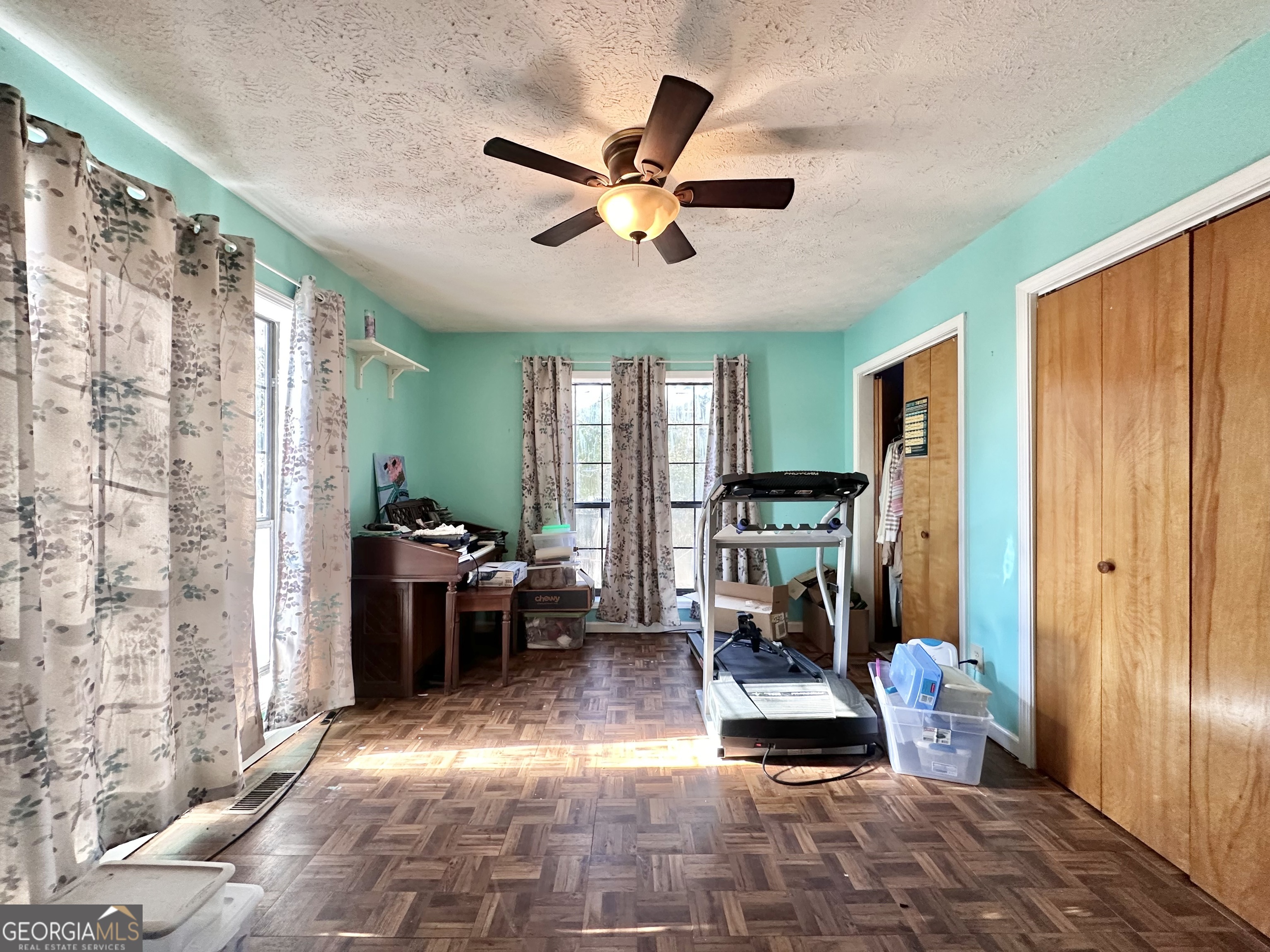 276 Oglesby Bridge Road Southeast Conyers, GA 30094 - Photo 39 of 49 a room with lots of furniture a chandelier fan and a large window