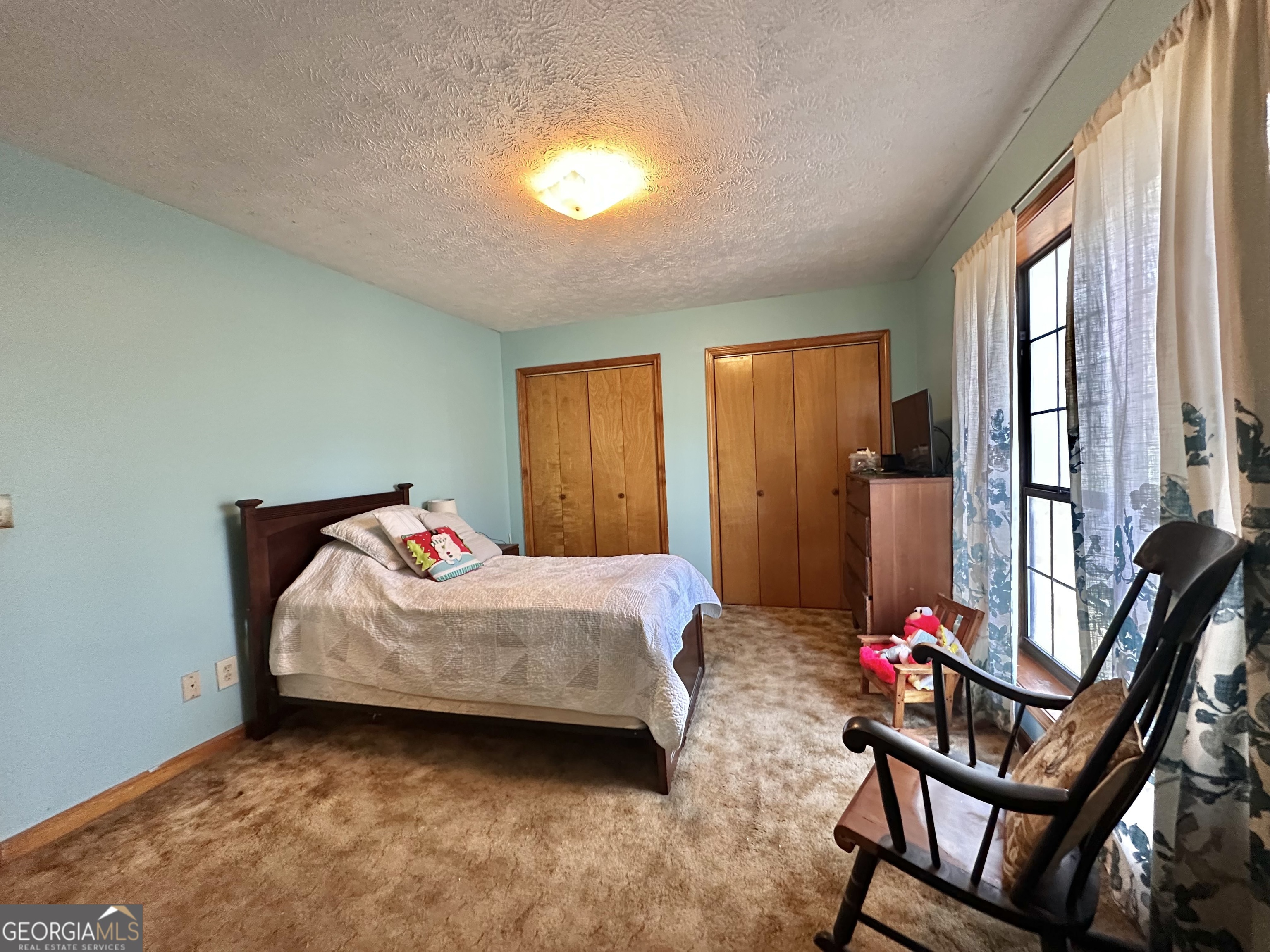 276 Oglesby Bridge Road Southeast Conyers, GA 30094 - Photo 42 of 49 a bedroom with a bed and a potted plant