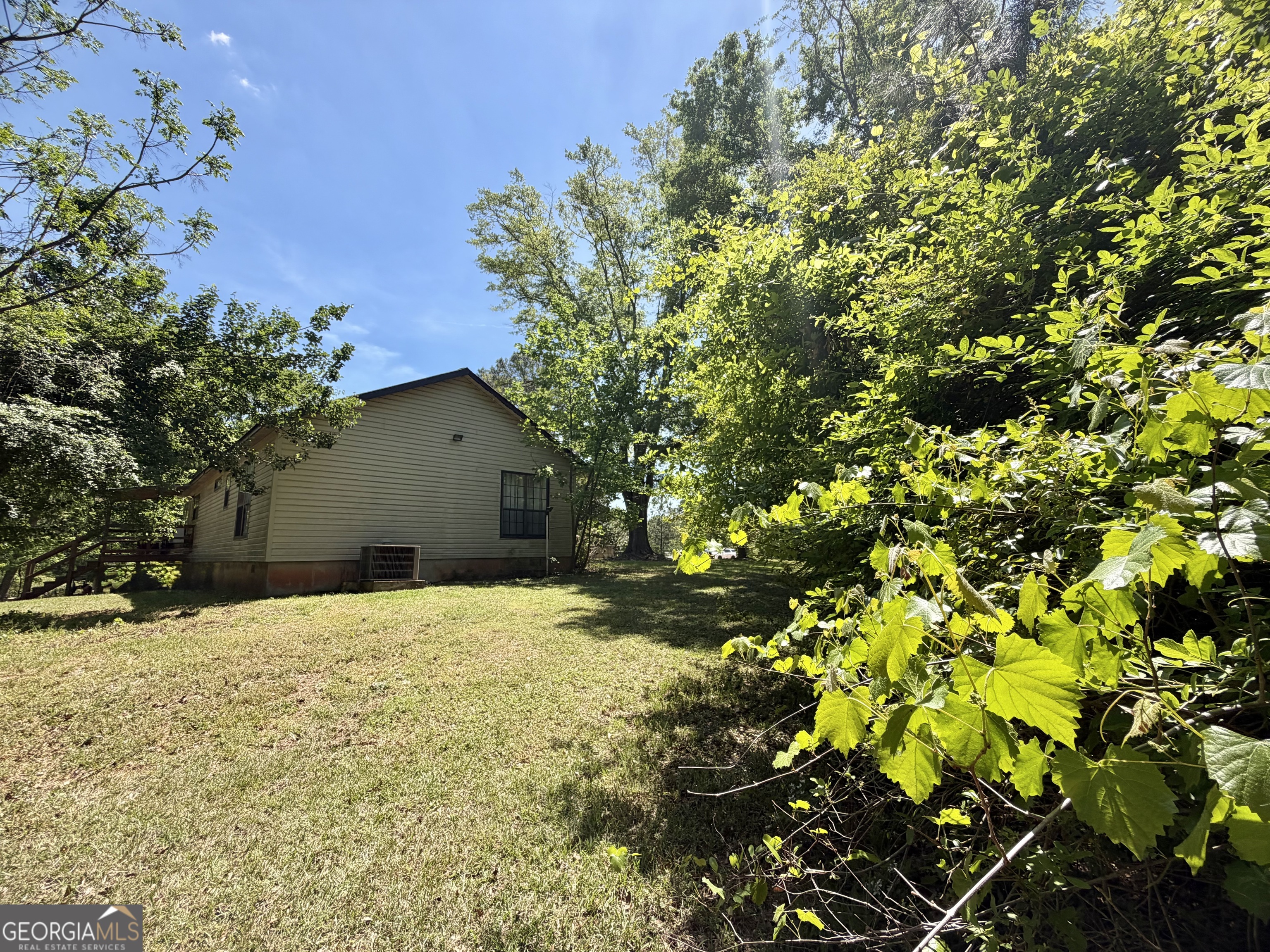 276 Oglesby Bridge Road Southeast Conyers, GA 30094 - Photo 5 of 49 a house with a tree in the background