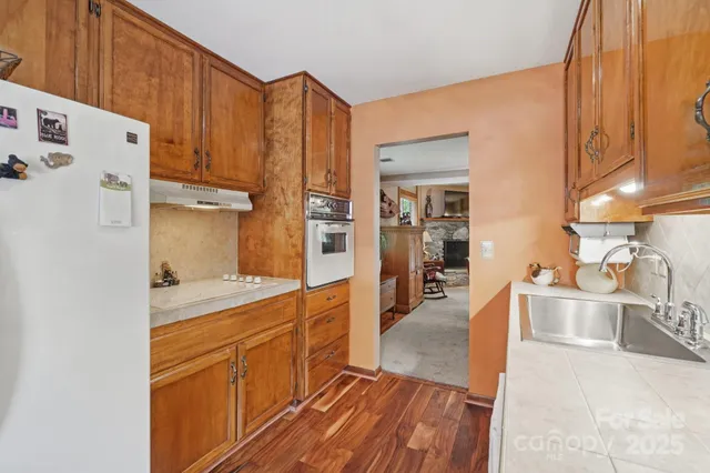 a large kitchen with stainless steel appliances a refrigerator and a sink