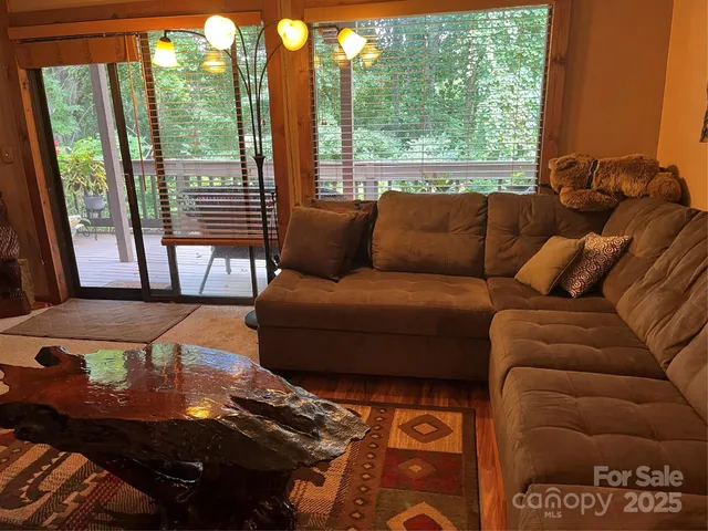 a living room with furniture and a floor to ceiling window
