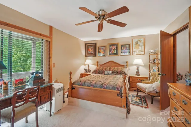 a bedroom with a bed and a large window