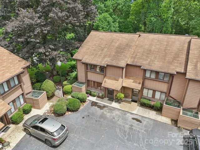 aerial view of a house with a yard and potted plants