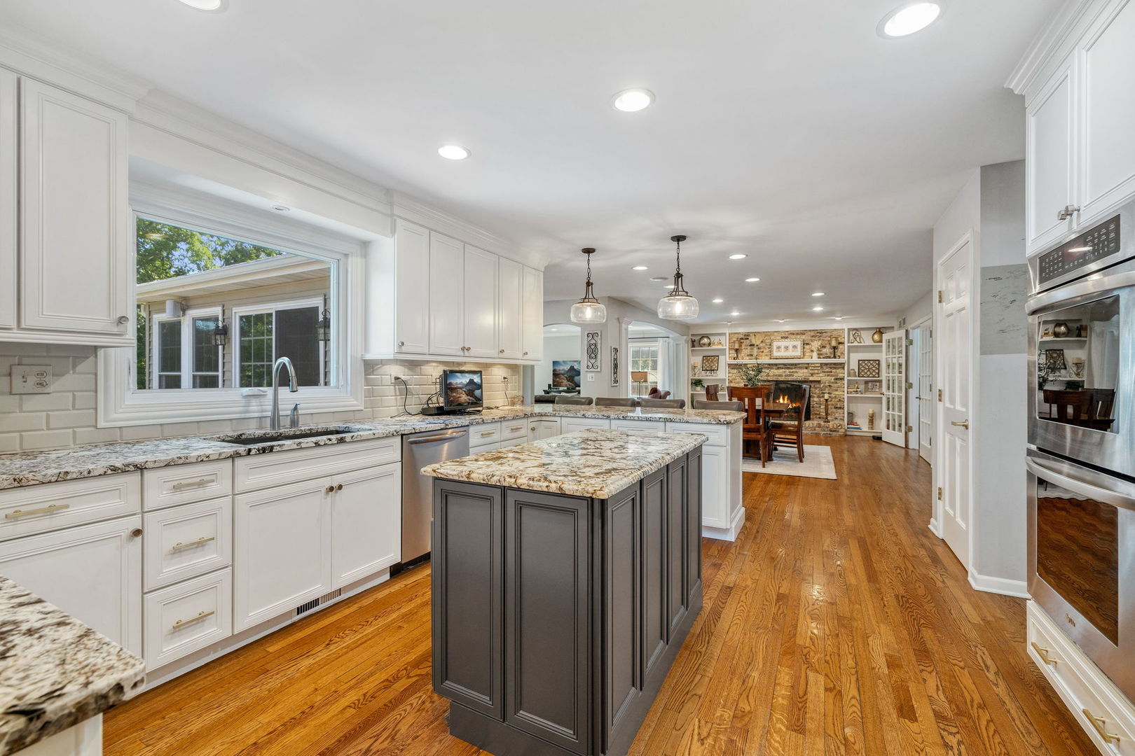 453 Brighton Drive Wheaton, IL 60189 - Photo 11 of 40 a kitchen with granite countertop kitchen island wooden floor and center island
