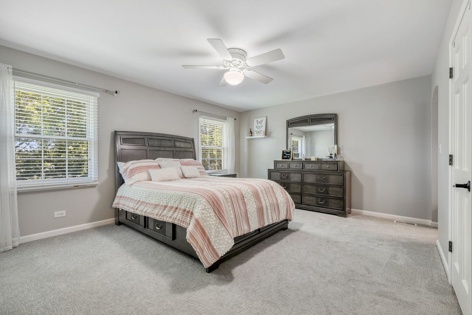 453 Brighton Drive Wheaton, IL 60189 - Photo 27 of 40 a spacious bedroom with a bed and a chandelier