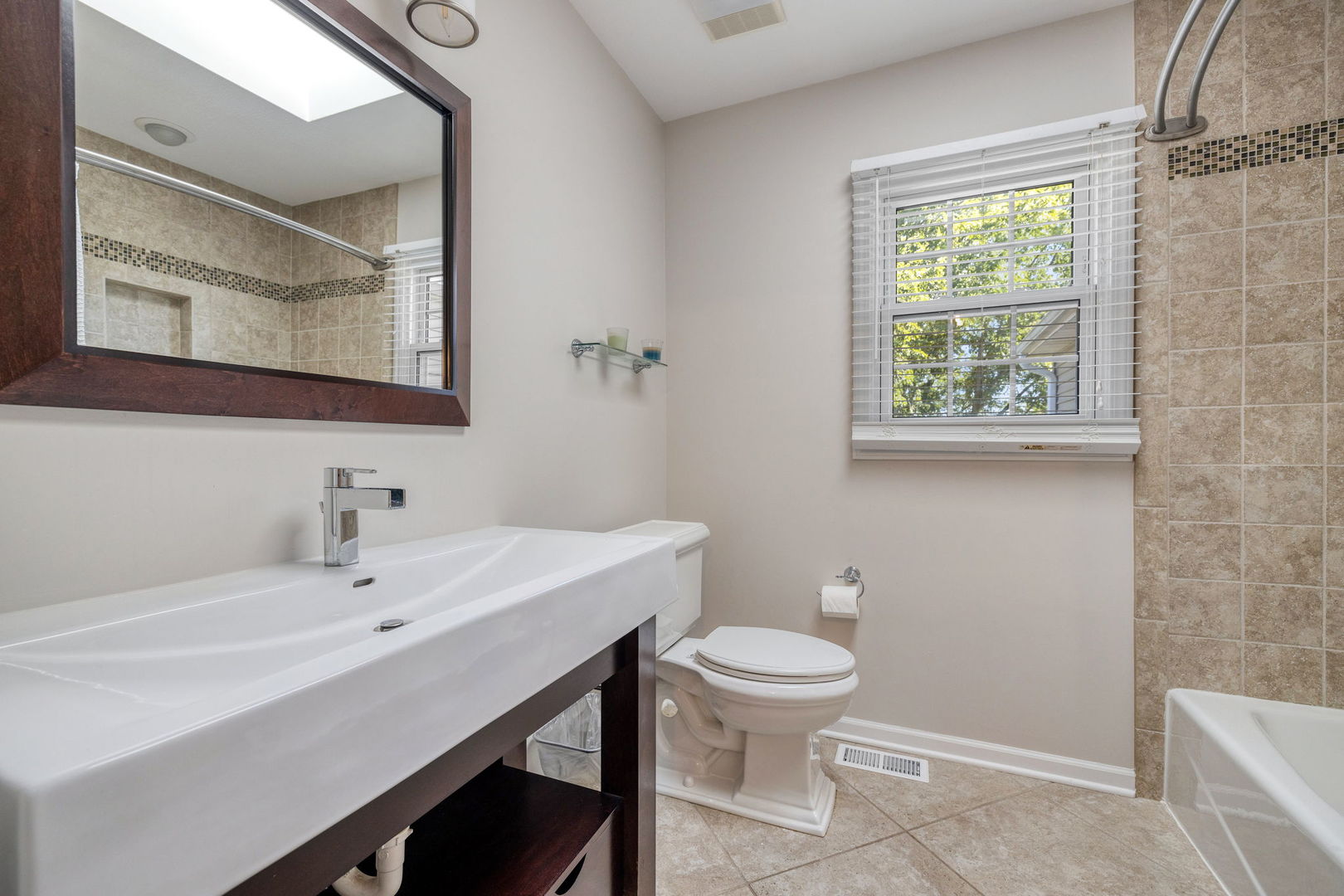 453 Brighton Drive Wheaton, IL 60189 - Photo 28 of 40 a bathroom with a sink a mirror and a toilet