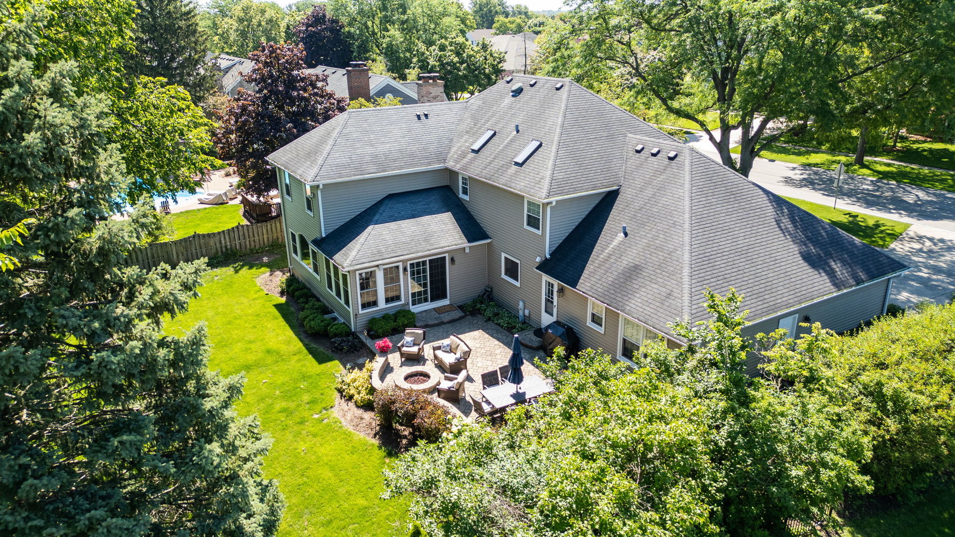 453 Brighton Drive Wheaton, IL 60189 - Photo 4 of 40 an aerial view of a house with a garden and large trees