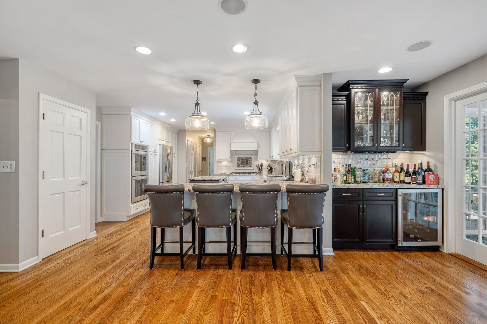 453 Brighton Drive Wheaton, IL 60189 - Photo 8 of 40 a large kitchen with a table and chairs