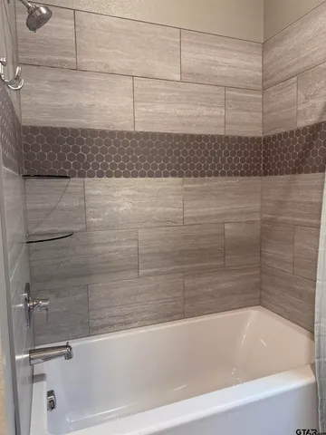 a bathroom with a bathtub and a shower