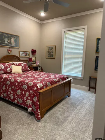 a bed room with a bed and a chair