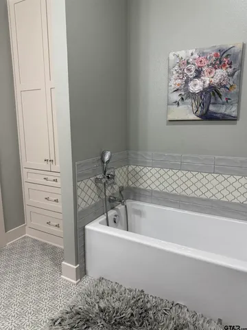 a bathroom with a bathtub and a shower