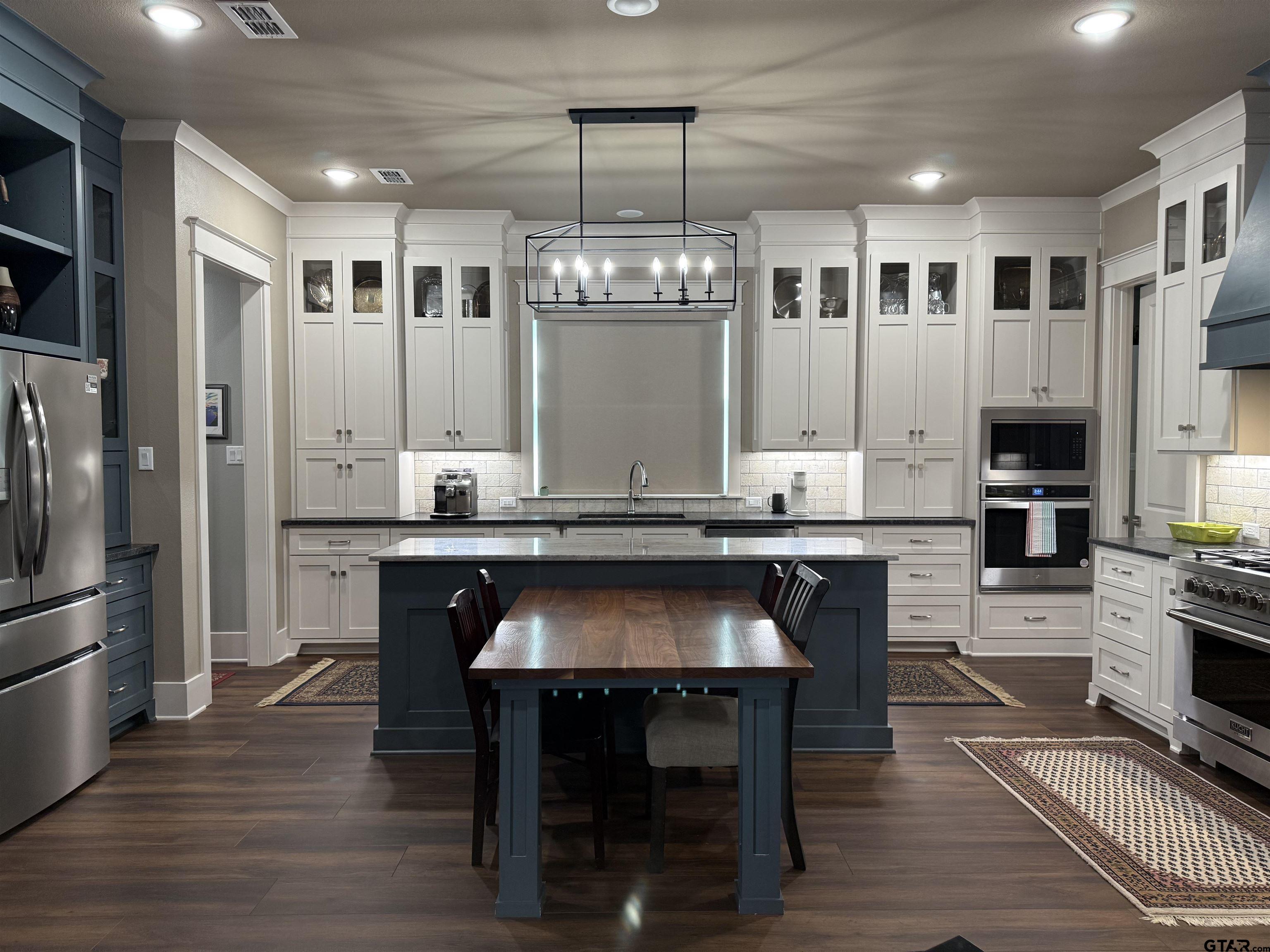 313 Sunset Circle Bullard, TX 75757 - Photo 37 of 48 a kitchen with a refrigerator and a stove top oven