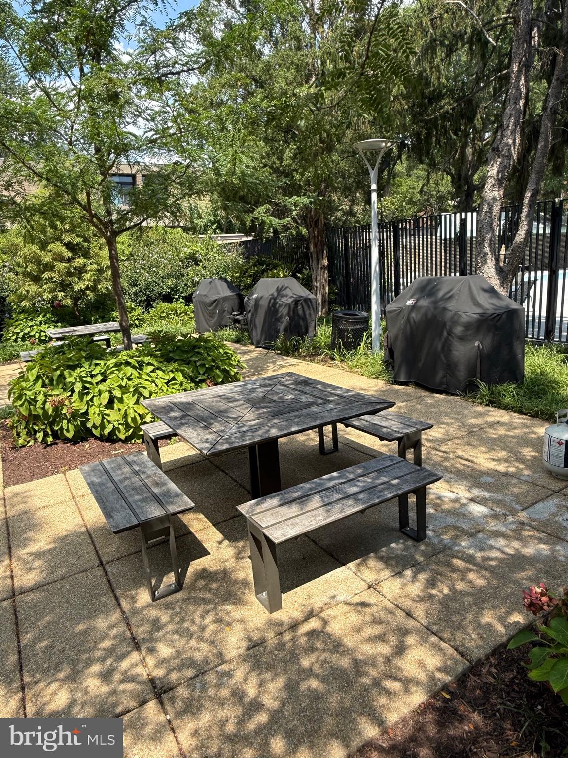 1311 Delaware Avenue Southwest, Unit S540 Washington, DC 20024 - Photo 9 of 17 a view of a patio with table and chairs and potted plants