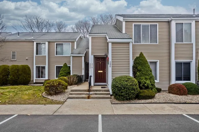 a view of a house with a yard and a garage