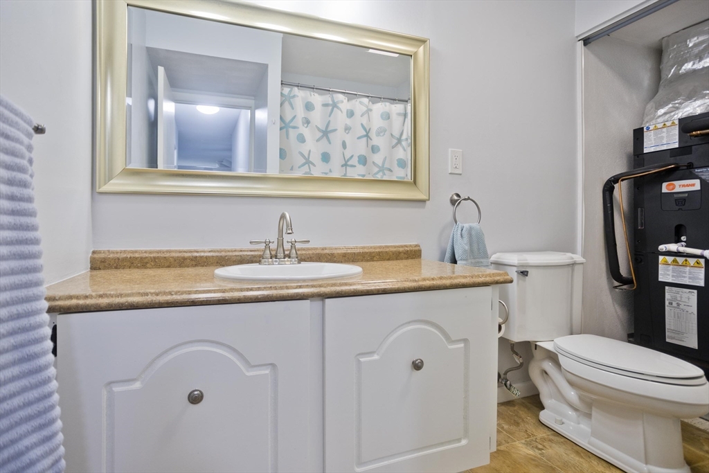 286 Nassau Drive, Unit 286 Springfield, MA 01129 - Photo 13 of 19 a bathroom with a granite countertop toilet sink and mirror