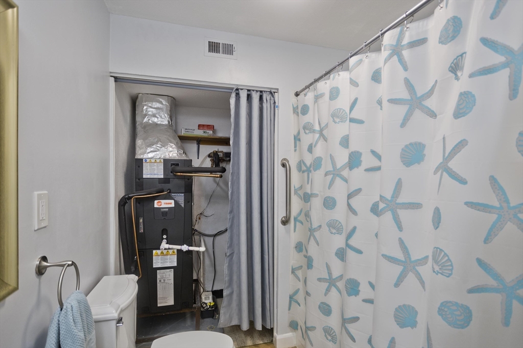 286 Nassau Drive, Unit 286 Springfield, MA 01129 - Photo 14 of 19 a bathroom with a shower curtain and a sink