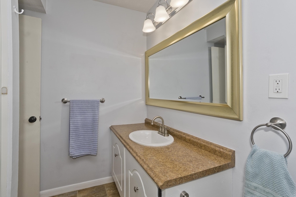 286 Nassau Drive, Unit 286 Springfield, MA 01129 - Photo 15 of 19 a bathroom with a sink granite vanity and a mirror