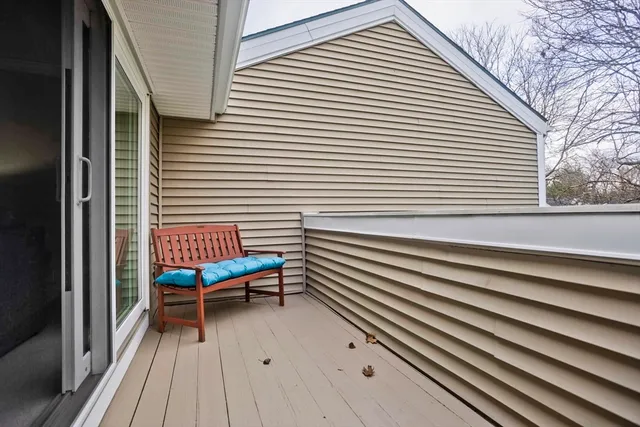 a view of a patio with a table and chairs and wooden floor