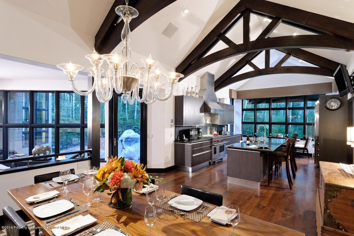 416 Moore Drive Aspen, CO 81611 - Photo 15 of 28 a living room with couches a dining table and chairs with floor to ceiling window