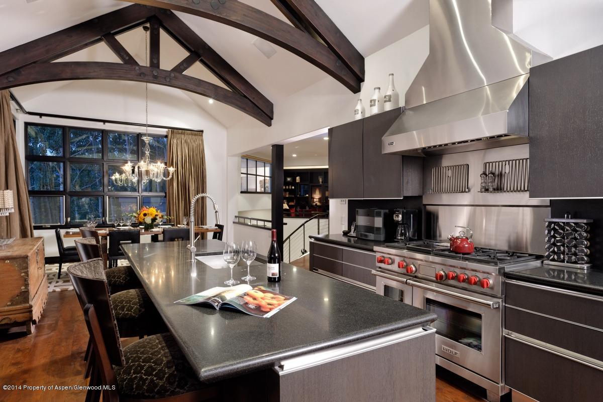 416 Moore Drive Aspen, CO 81611 - Photo 16 of 28 a kitchen with a table chairs stove and cabinets