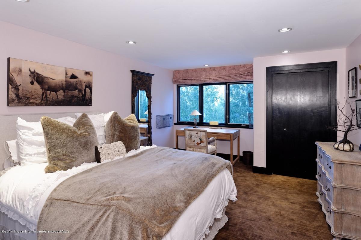 416 Moore Drive Aspen, CO 81611 - Photo 21 of 28 a bedroom with a balcony a bed and a large window