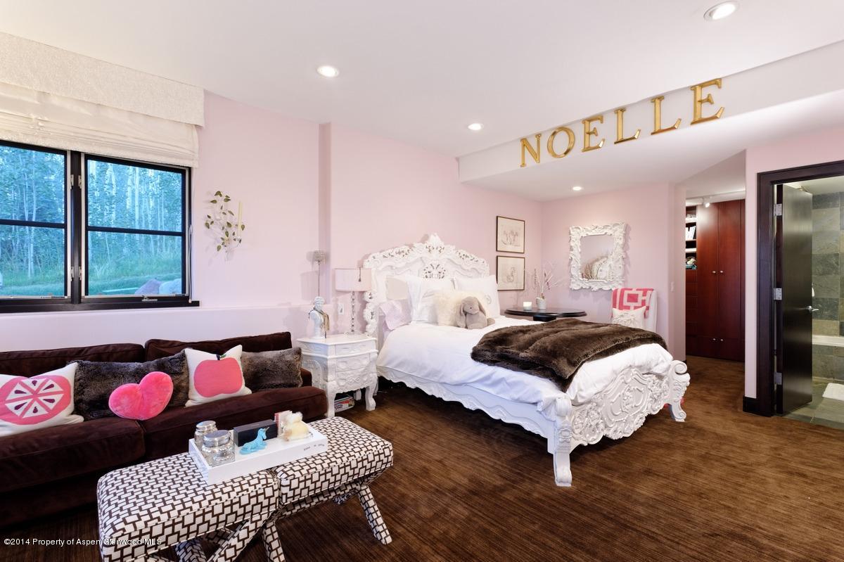 416 Moore Drive Aspen, CO 81611 - Photo 26 of 28 a bedroom with a bed and wooden floor