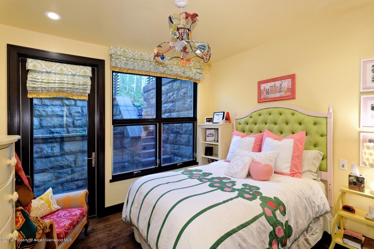 416 Moore Drive Aspen, CO 81611 - Photo 27 of 28 a bedroom with a bed and wooden floor