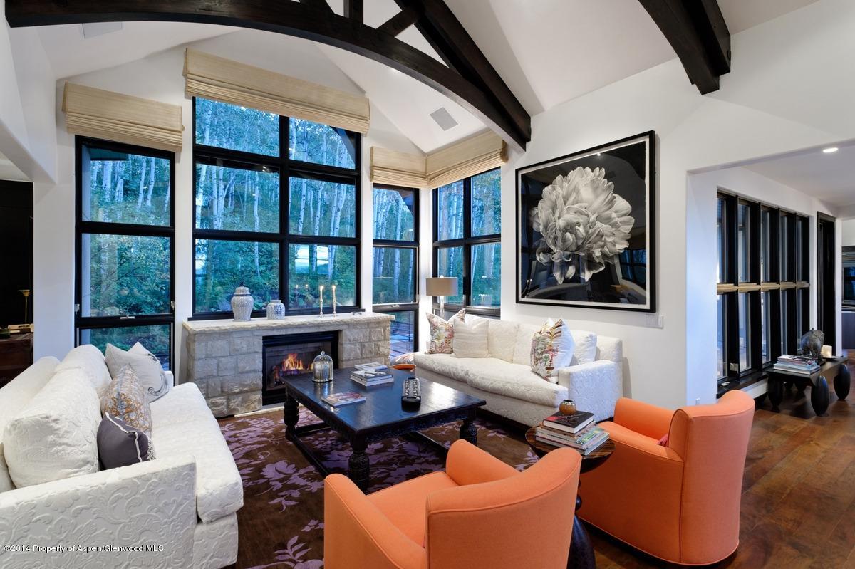 416 Moore Drive Aspen, CO 81611 - Photo 8 of 28 a living room with furniture a flat screen tv and a floor to ceiling window