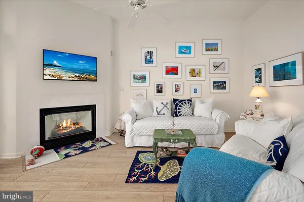 a living room with furniture and a refrigerator