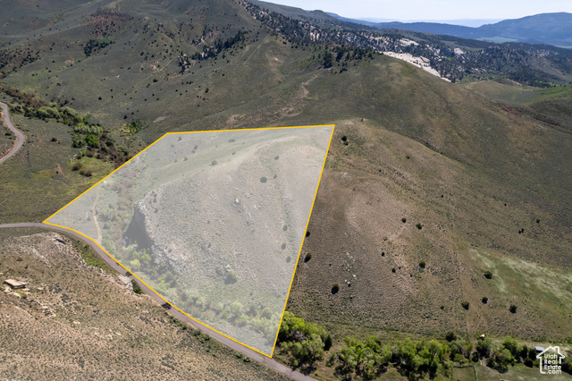 19204 Paradise Park Road, Unit 6 Vernal, UT 84078 - Photo 2 of 14 Aerial view of sparsely populated area featuring a mountainous background and property parcel outlined