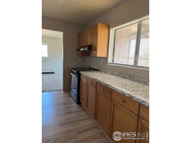 a kitchen with stainless steel appliances granite countertop a sink and wooden cabinets