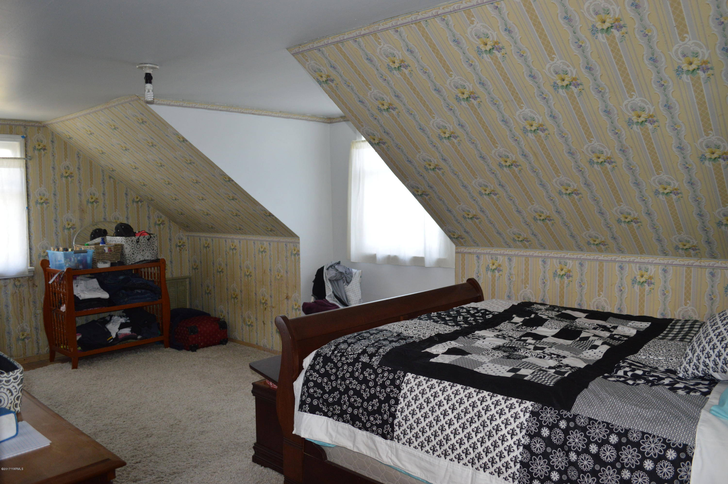 6941 McDonald Road Wapato, WA 98951 - Photo 18 of 24 a bed in a room next to a window