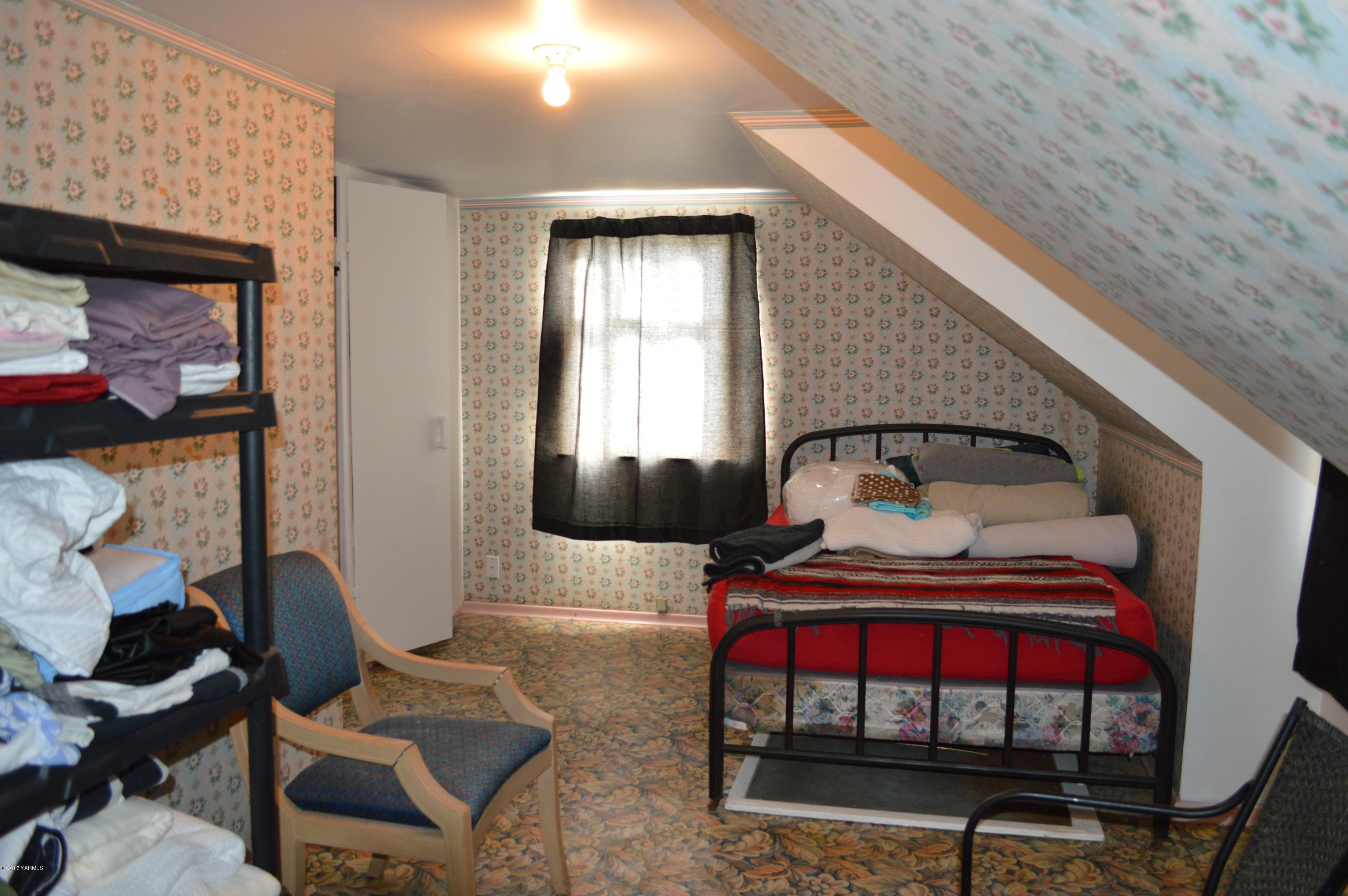 6941 McDonald Road Wapato, WA 98951 - Photo 20 of 24 a bedroom with furniture and a window