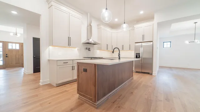 a view of a kitchen with white cabinets and a sink
